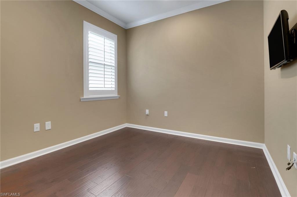 10588 Jackson Square Drive Estero, FL 33928 - Photo 21 of 50 an empty room with wooden floor and windows