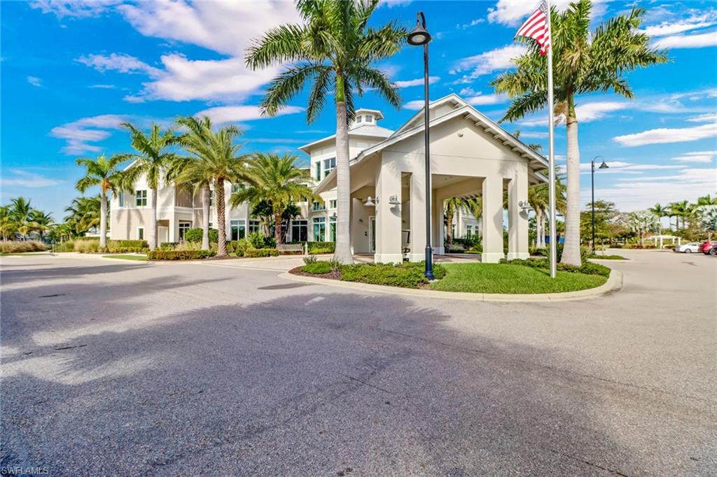 10588 Jackson Square Drive Estero, FL 33928 - Photo 30 of 50 a view of a white house with a yard