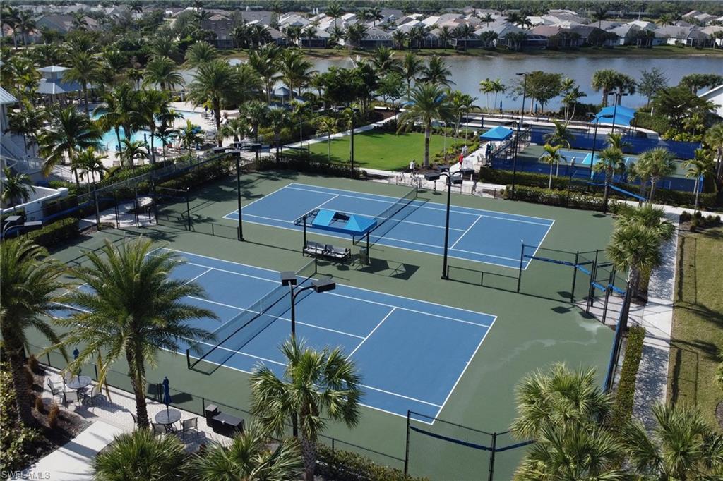 10588 Jackson Square Drive Estero, FL 33928 - Photo 43 of 50 a view of a swimming pool with lawn chairs and potted plants