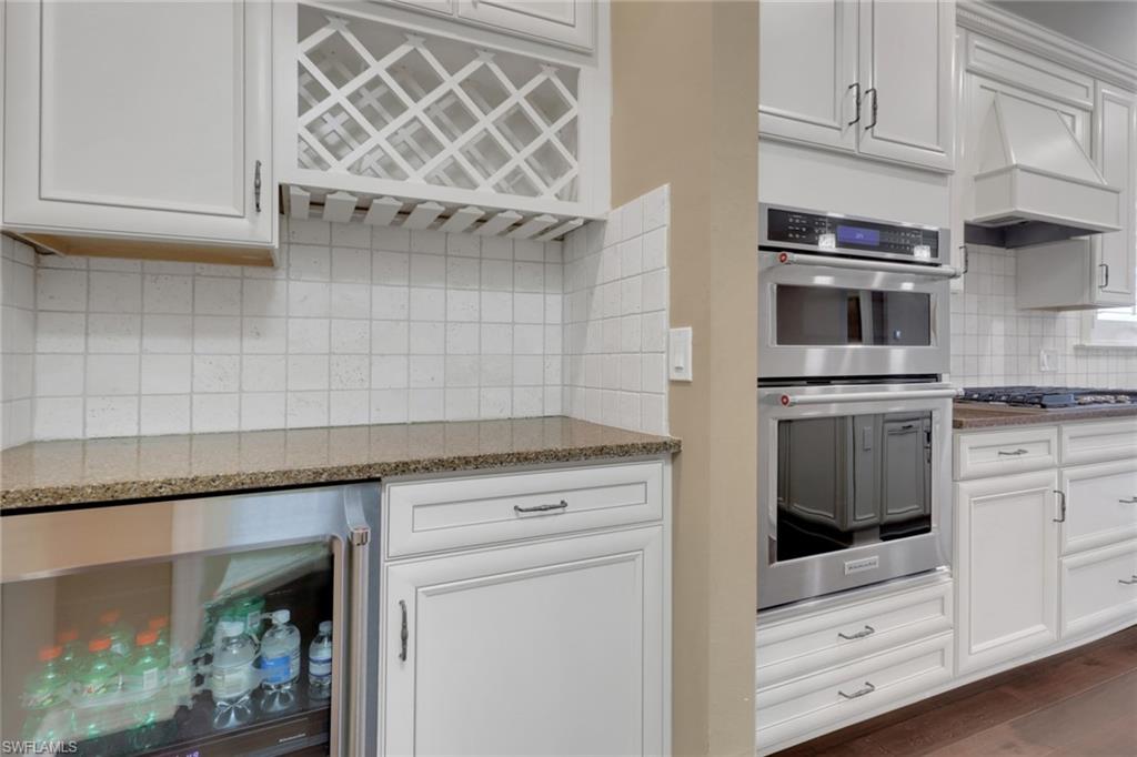 10588 Jackson Square Drive Estero, FL 33928 - Photo 10 of 50 a kitchen with granite countertop a stove and a microwave