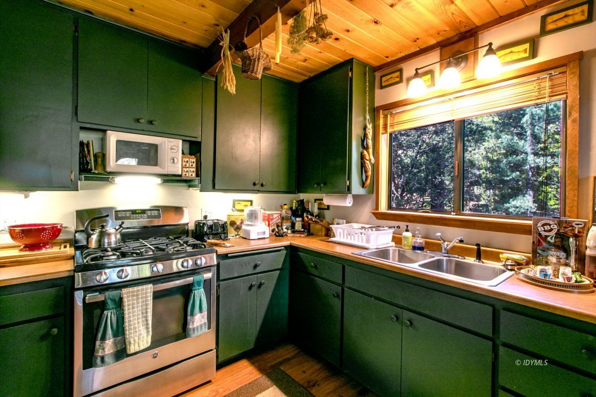 52641 4s02 Idyllwild, CA 92549 - Photo 9 of 36 a kitchen with stainless steel appliances a sink stove and cabinets
