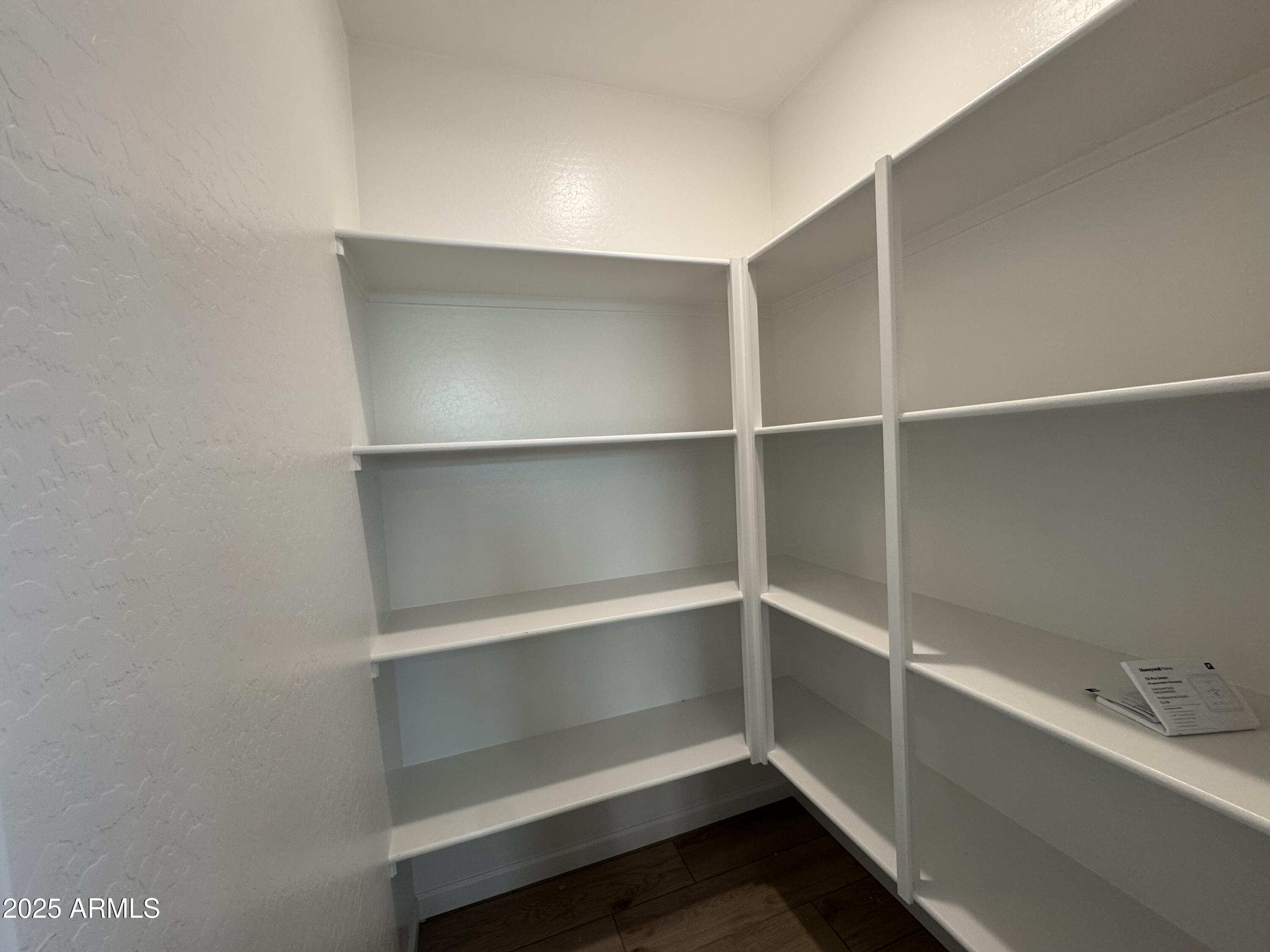 15720 West Camden Avenue Waddell, AZ 85355 - Photo 11 of 32 a view of an empty walk in closet