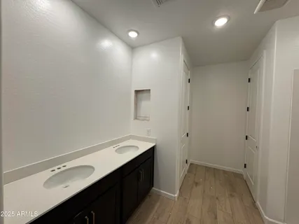a bathroom with a double vanity sink and a mirror