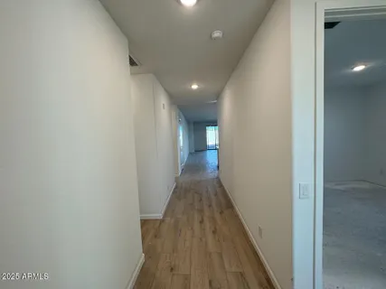 a view of a hallway with wooden floor