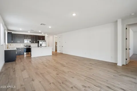 a kitchen with a sink a counter top space stainless steel appliances and cabinets