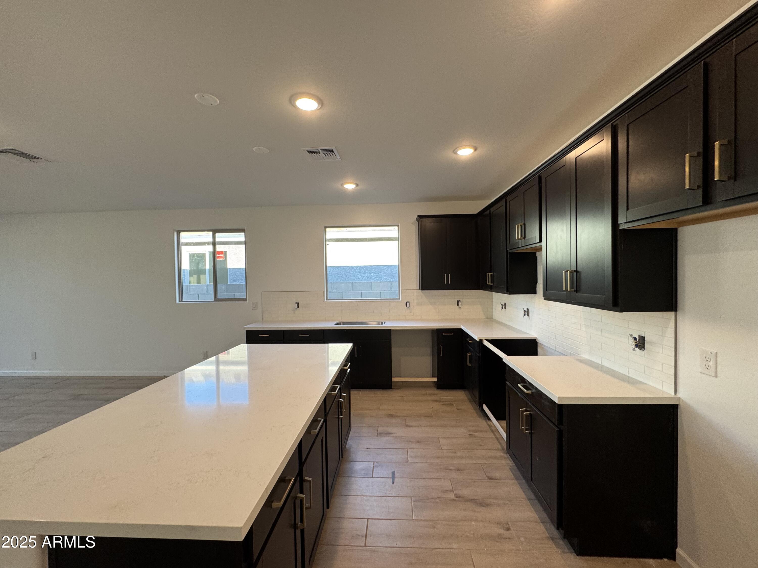 15720 West Camden Avenue Waddell, AZ 85355 - Photo 8 of 32 a large kitchen with lots of counter space