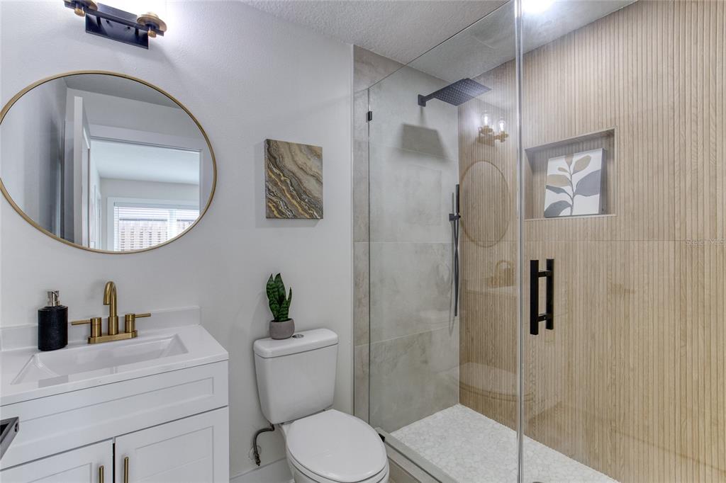 9 Soco Trail Ormond Beach, FL 32174 - Photo 13 of 74 a bathroom with a toilet a sink and a mirror