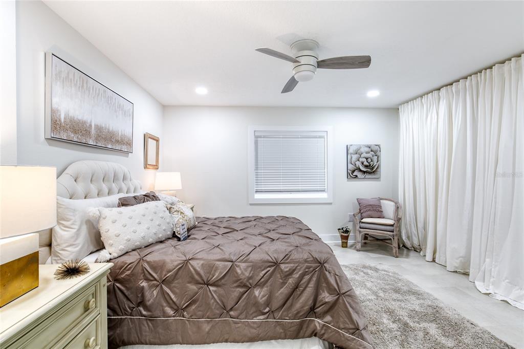 9 Soco Trail Ormond Beach, FL 32174 - Photo 29 of 74 a bedroom with a bed and a chair