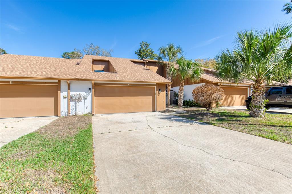 9 Soco Trail Ormond Beach, FL 32174 - Photo 3 of 74 a front view of a house with a yard and garage