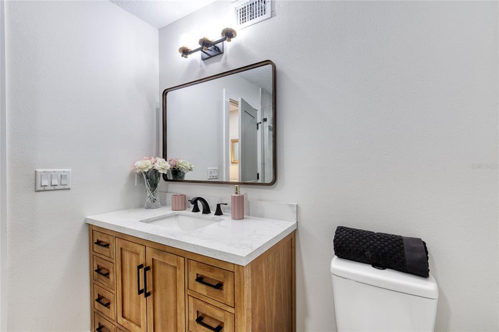 9 Soco Trail Ormond Beach, FL 32174 - Photo 32 of 74 a bathroom with a toilet sink and mirror