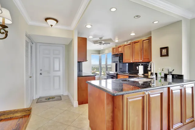 a kitchen with stainless steel appliances granite countertop a sink stove and cabinets