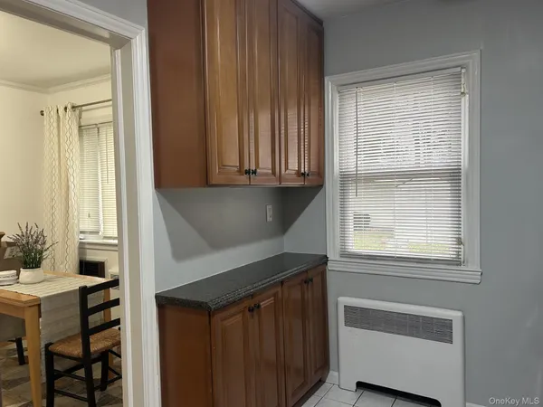 a kitchen with a sink cabinets and a window