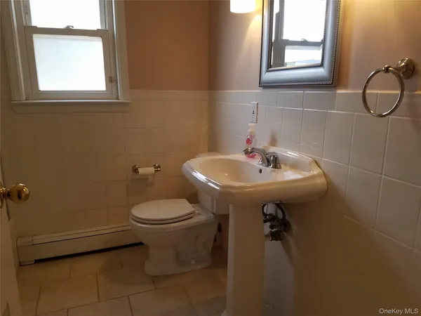 a bathroom with a sink toilet and a mirror