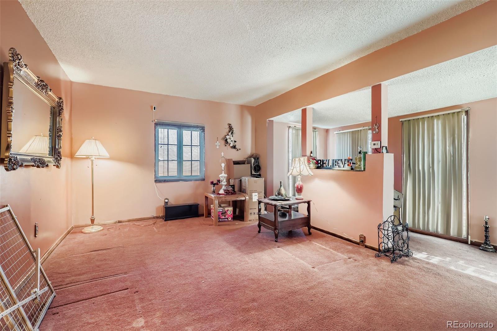 657 Meade Street Denver, CO 80204 - Photo 3 of 17 a bed room with furniture and a window