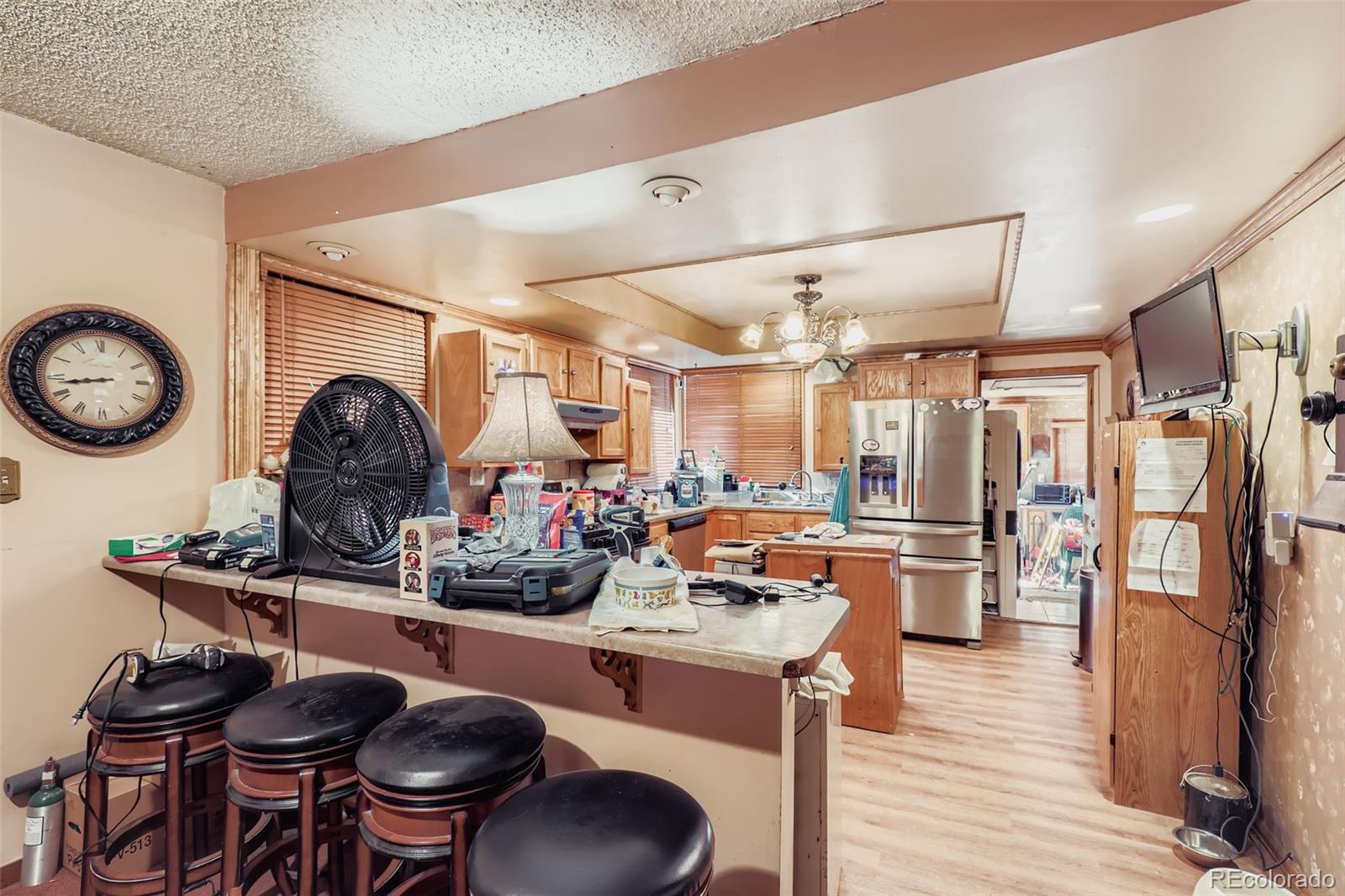 657 Meade Street Denver, CO 80204 - Photo 6 of 17 a kitchen with stainless steel appliances granite countertop a stove and a refrigerator