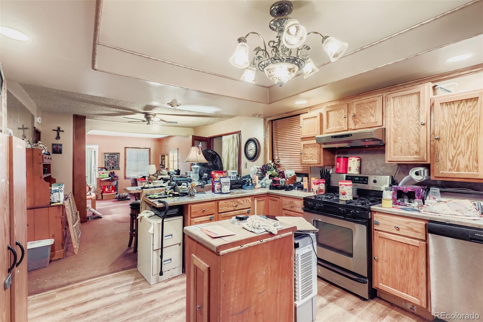 657 Meade Street Denver, CO 80204 - Photo 7 of 17 a kitchen filled with stainless steel appliances granite countertop a sink and cabinets