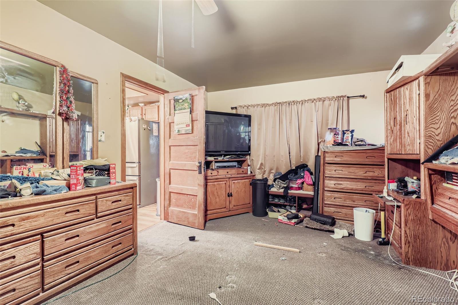 657 Meade Street Denver, CO 80204 - Photo 9 of 17 a view of room with furniture and a refrigerator