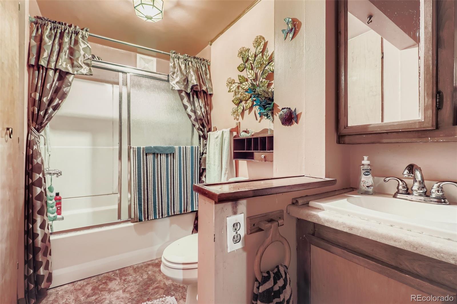 657 Meade Street Denver, CO 80204 - Photo 10 of 17 a bathroom with a sink a toilet and shower