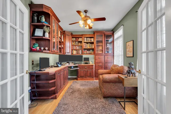 a work room with furniture and a bookshelf