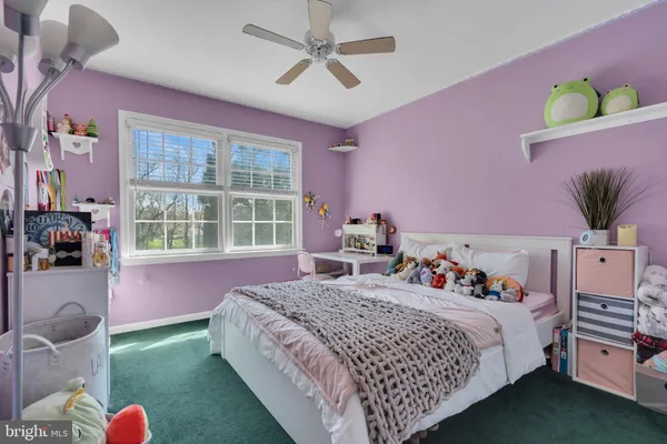 a bedroom with a bed a dresser and a window