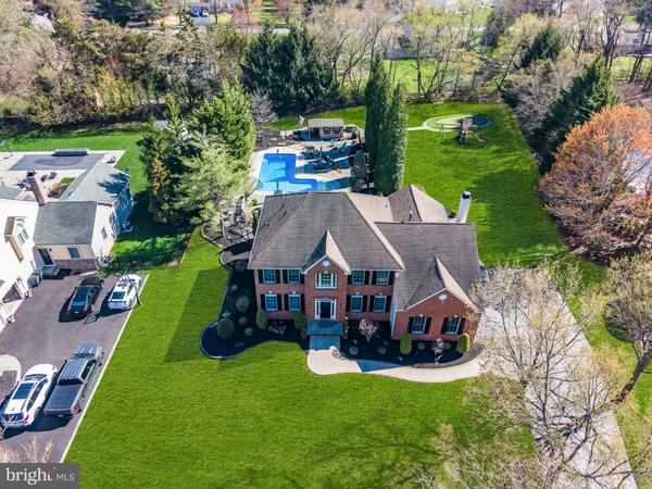 an aerial view of a house with yard and green space