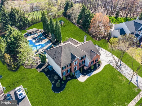 an aerial view of residential house with an outdoor space and seating