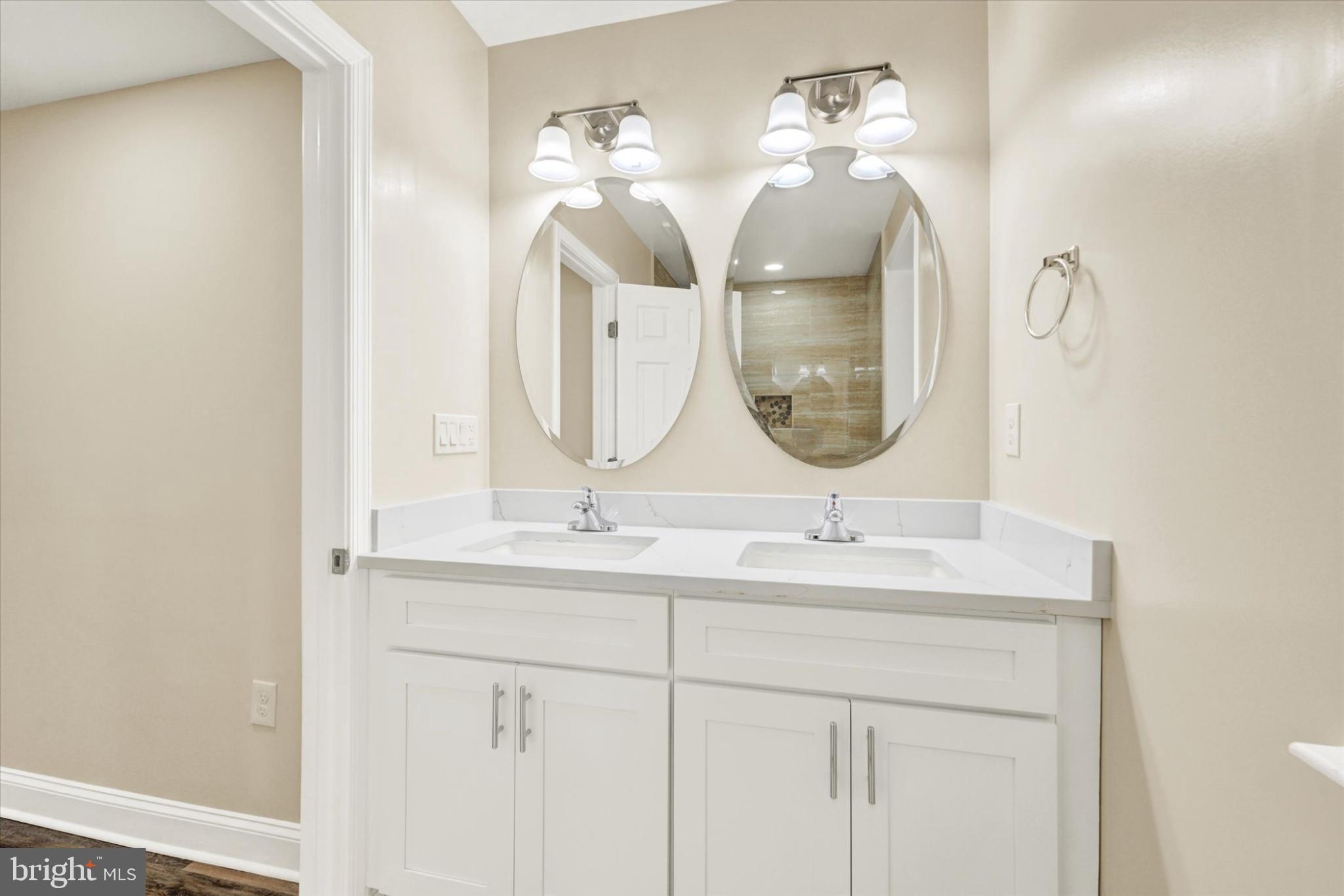 22 Cockeys Mill Road Reisterstown, MD 21136 - Photo 14 of 27 Elegant dual-sink vanity with modern mirrors.