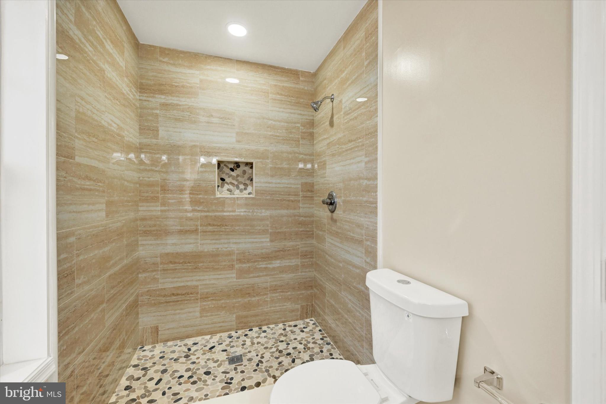 22 Cockeys Mill Road Reisterstown, MD 21136 - Photo 19 of 27 Elegant shower space with natural stone accents.