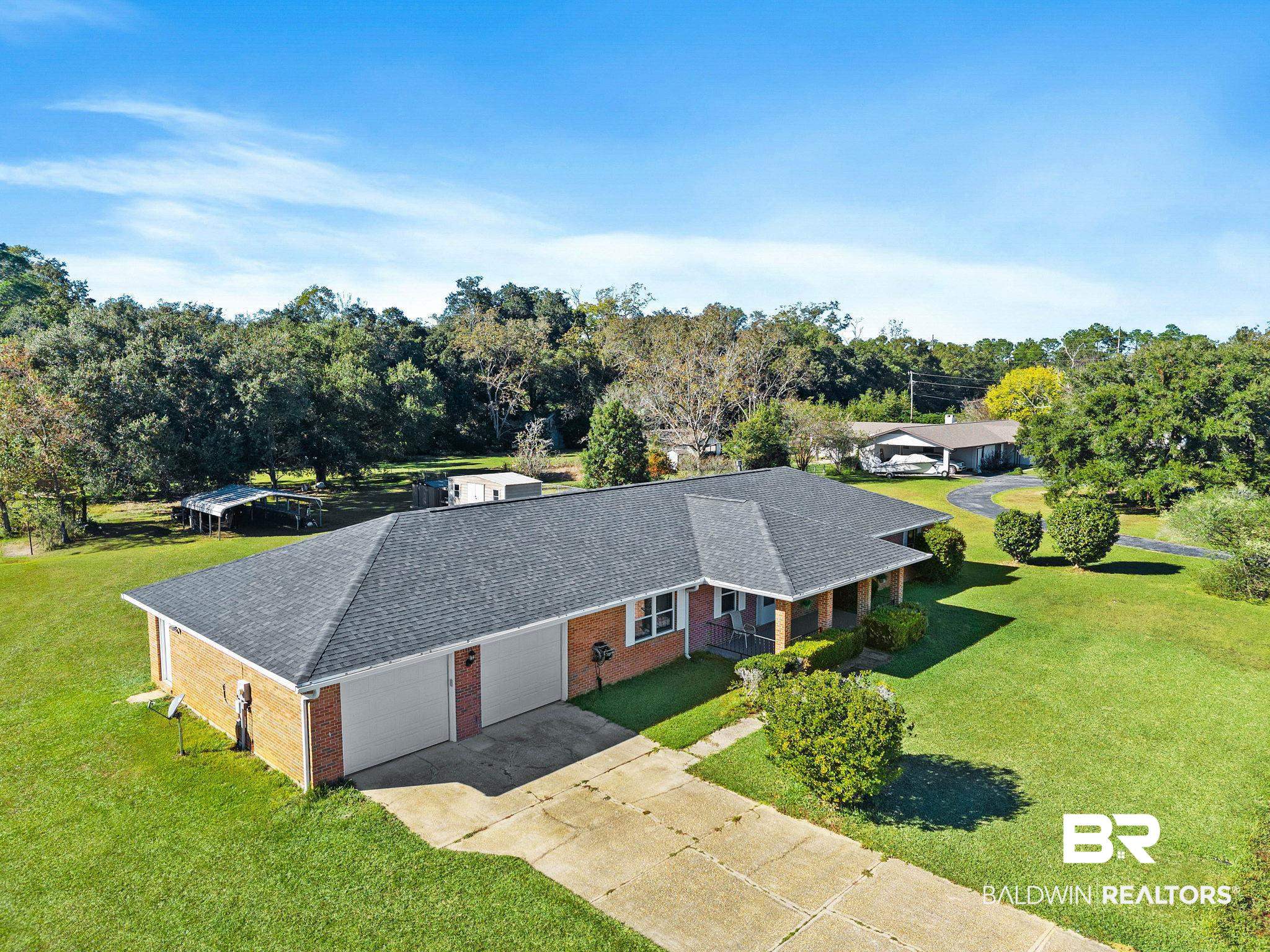 1510 South Juniper Street Foley, AL 36535 - Photo 3 of 36 Aerial view of property and surrounding area with a tree filled landscape