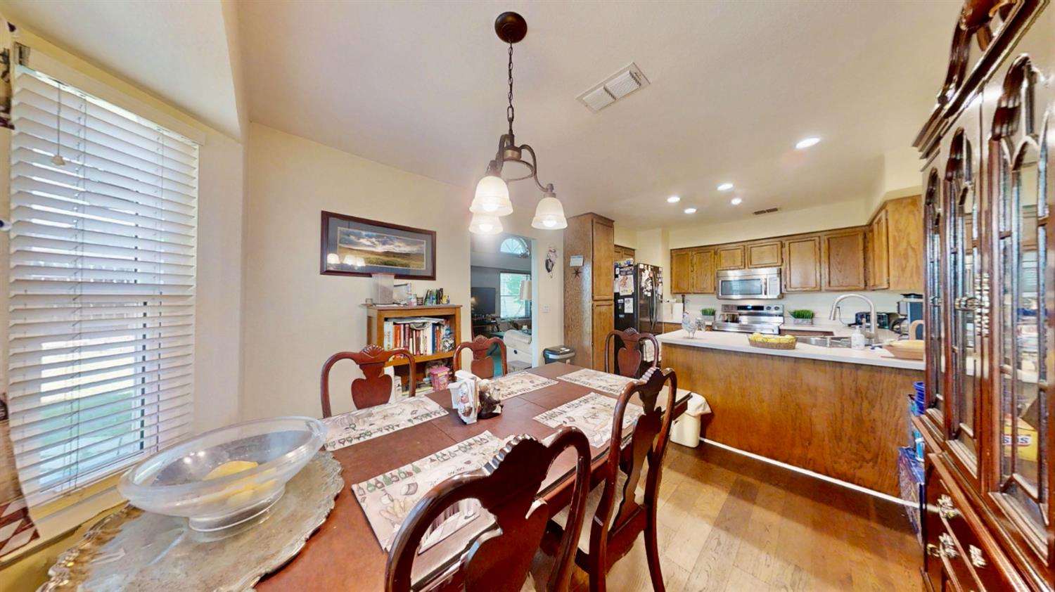 5161 Thomasino Way Antelope, CA 95843 - Photo 14 of 41 a dining room filled chandelier and wooden floor