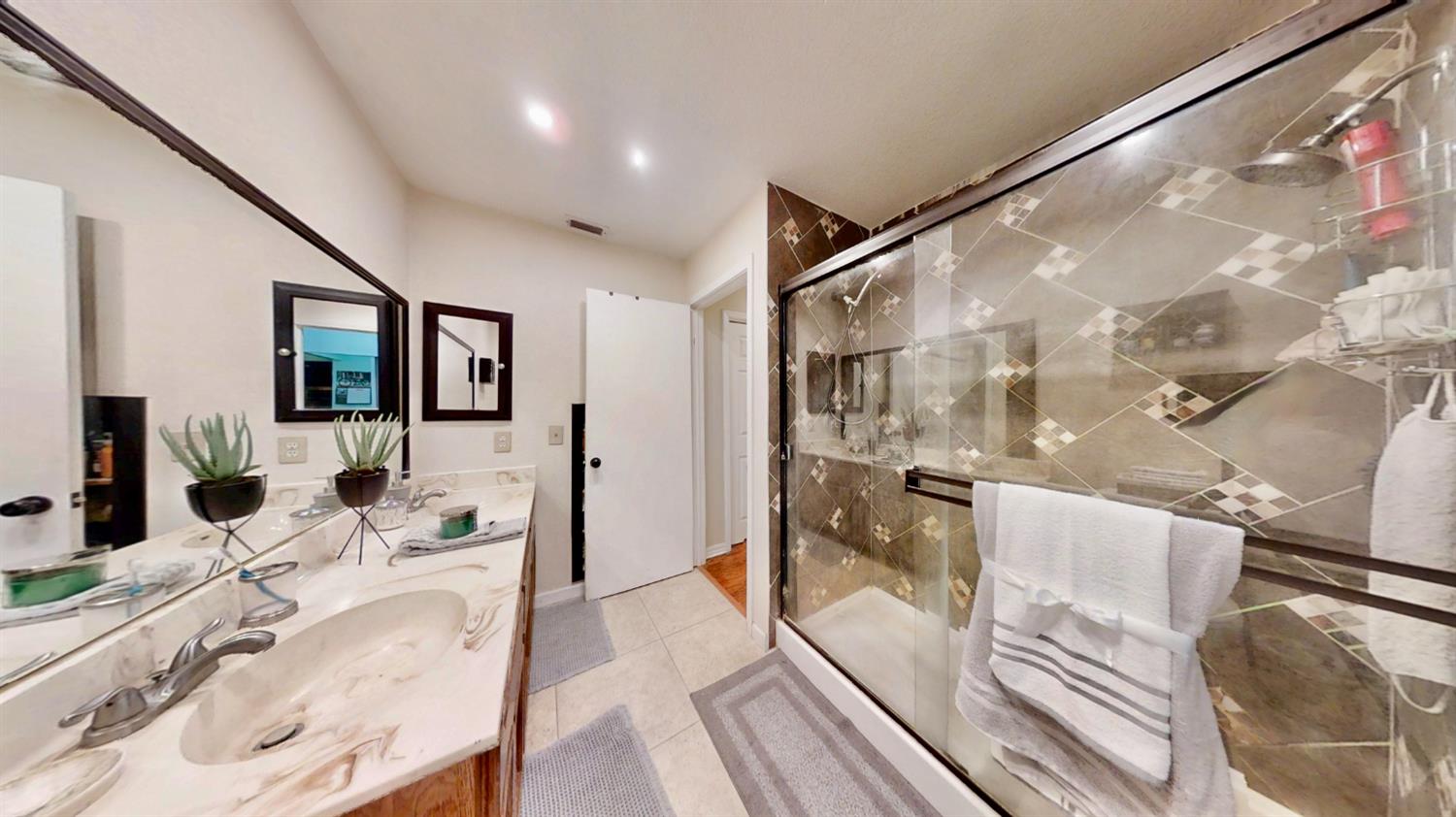 5161 Thomasino Way Antelope, CA 95843 - Photo 21 of 41 a bathroom with a granite countertop double vanity and a tub