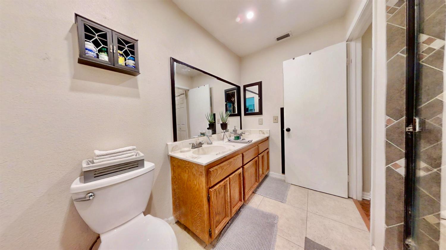 5161 Thomasino Way Antelope, CA 95843 - Photo 22 of 41 a bathroom with a sink a toilet and a mirror