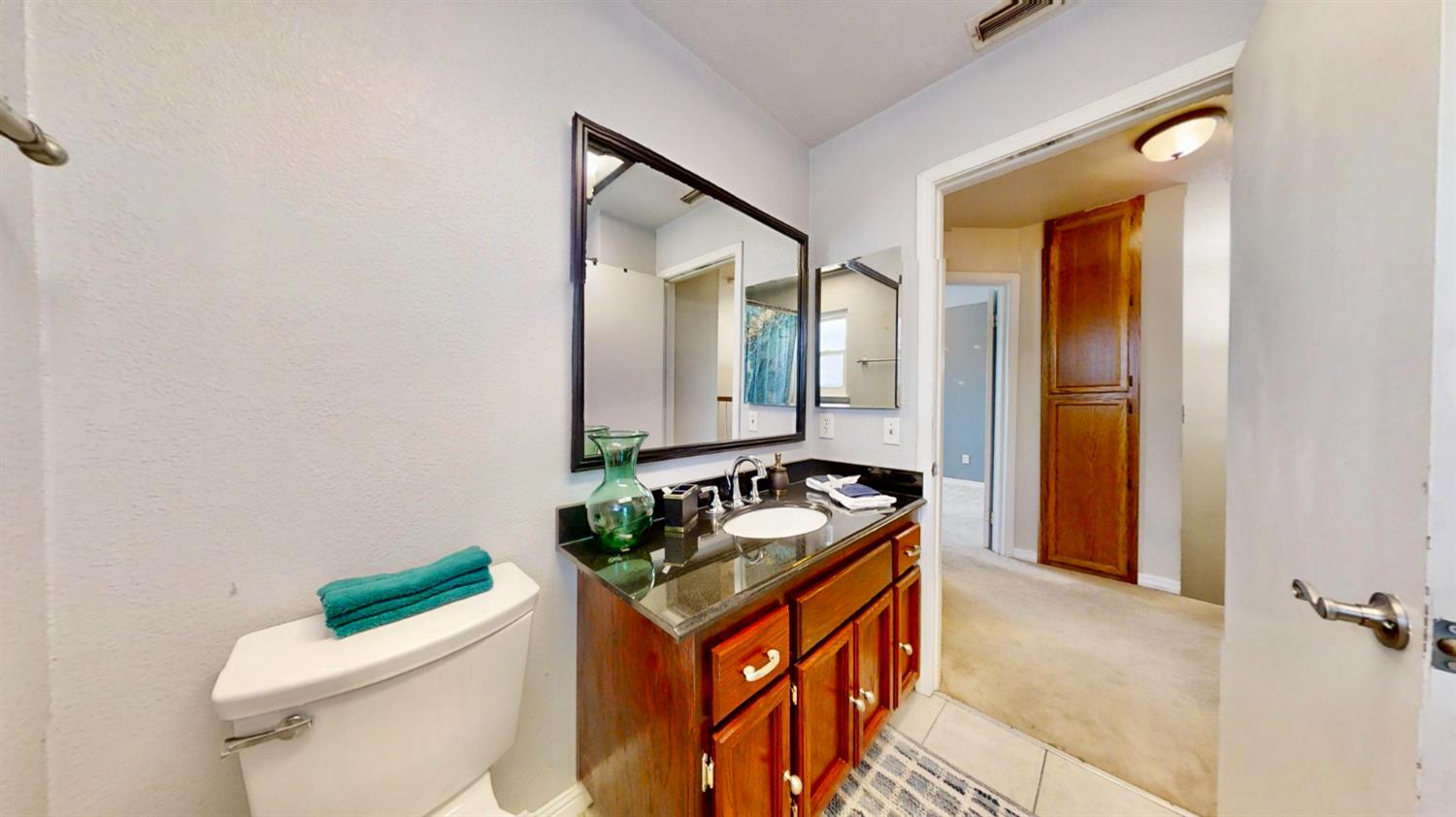 5161 Thomasino Way Antelope, CA 95843 - Photo 31 of 41 a bathroom with a granite countertop sink and a mirror