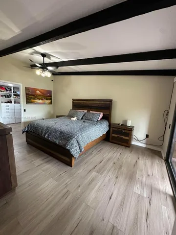 a bedroom with a bed and a night stand