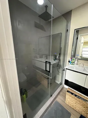 a bathroom with a shower and a sink