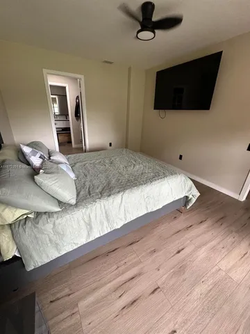 a bedroom with a bed and a flat screen tv