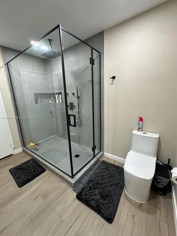 a bathroom with a shower and a toilet