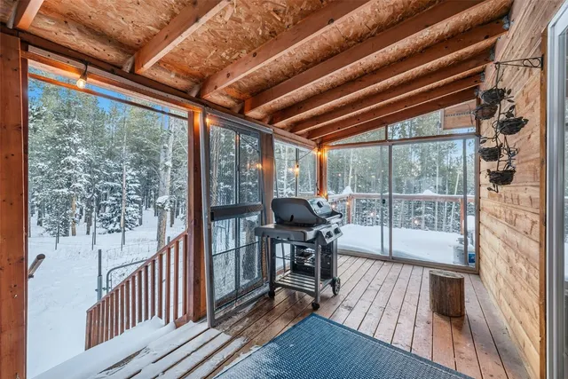 a bedroom with a large bed and wooden floor