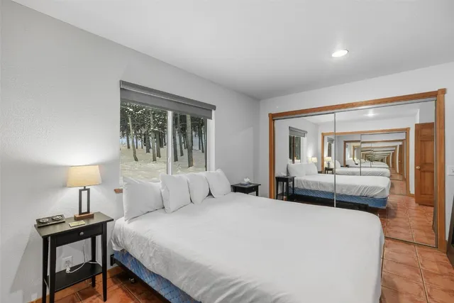 a bedroom with a bed and a mirror