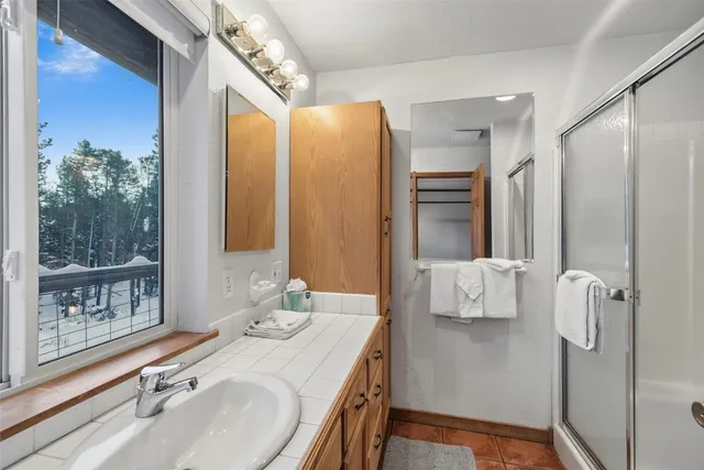 a view of a hallway with a livingroom and dining room with a mirror