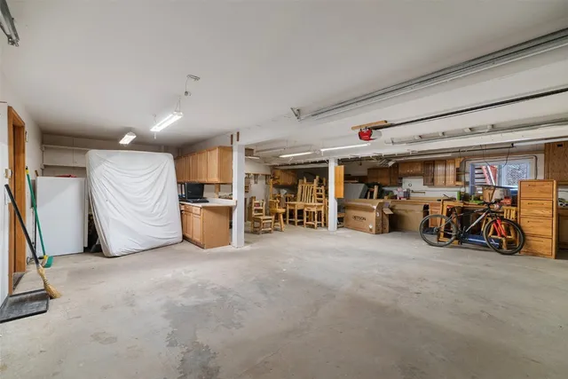 a front view of house with yard and trees in the background