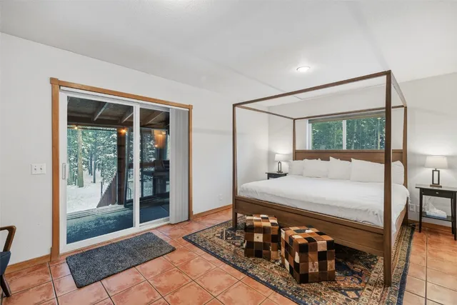 a bedroom with a bed and large window