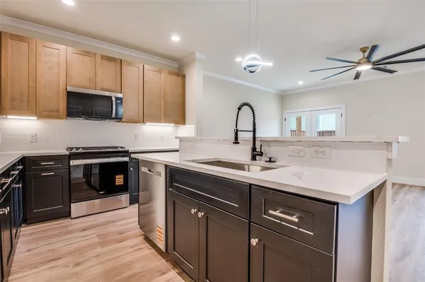 a kitchen with a sink stove and microwave