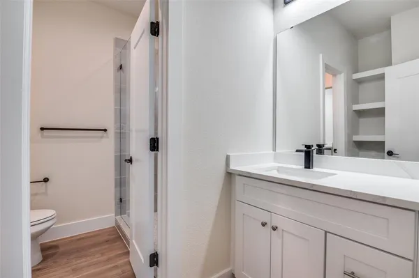 a bathroom with a sink a toilet and a large mirror