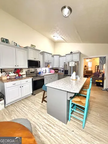 a kitchen with a sink appliances and cabinets
