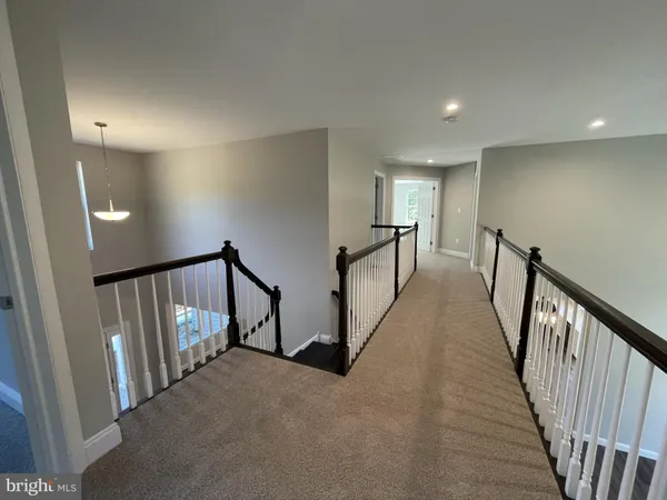a view of a hallway with stairs