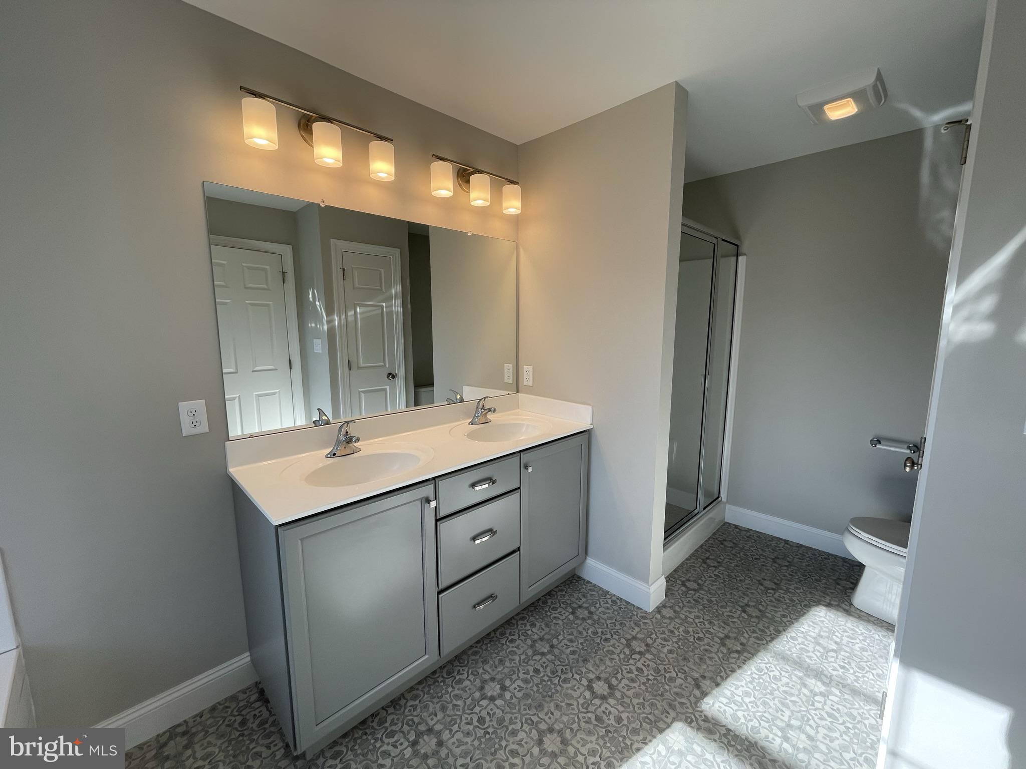 1600 Lower State Road Lower Gwynedd, PA 19002 - Photo 14 of 18 a bathroom with a double vanity sink and mirror