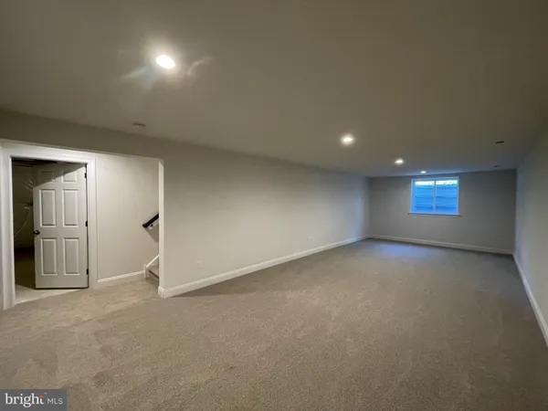 an empty room with windows and entrance