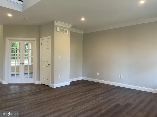 wooden floor in an empty room with wooden floor and a window