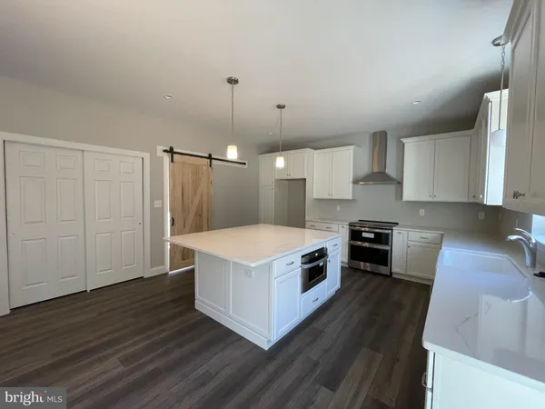 a kitchen with a stove and a refrigerator